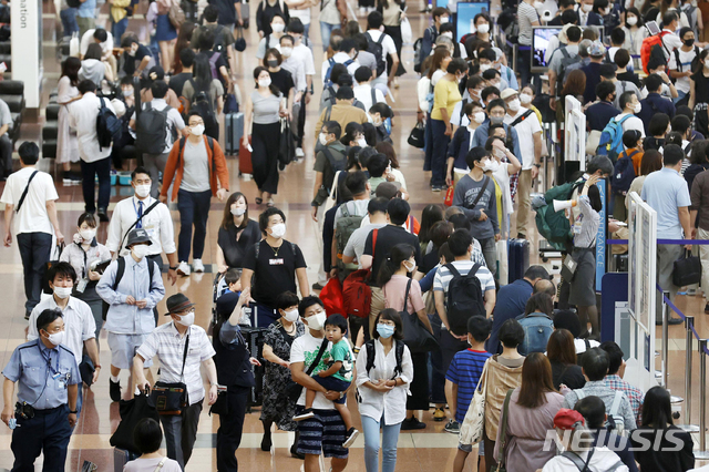 [도쿄=AP/뉴시스]지난달 19일 일본 도쿄 하네다 공항에 마스크를 쓴 이용객들이 붐비고 있다. 2020.09.23.