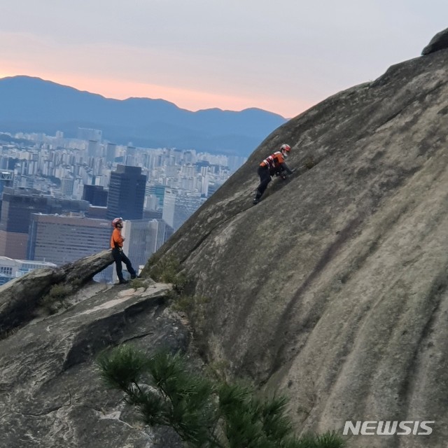 [서울=뉴시스] 지난 23일 오전 서울 서대문구 안산에서 20대 여성 A씨를 구조하기 위해 대원이 접근하는 모습. 2020.09.26 (사진 = 신촌지구대 제공) 