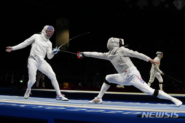 Andrew Mackiewicz of the United States, left, and Oh Sanguk of South Korea compete in the men's individual round of 32 Sabre competition at the 2020 Summer Olympics, Saturday, July 24, 2021, in Chiba, Japan. (AP Photo/Andrew Medichini)