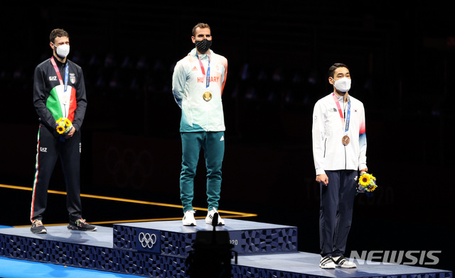 [지바(일본)=뉴시스] 이영환 기자 = 대한민국 펜싱 대표 김정환이 24일 오후 일본 지바 마쿠하리 메세 B홀에서 열린 도쿄올림픽 펜싱 남자 사브르 개인전 메달수여식에서 동메달을 목에 걸고 태극기를 바라보고 있다. 2021.07.24. 20hwan@newsis.com