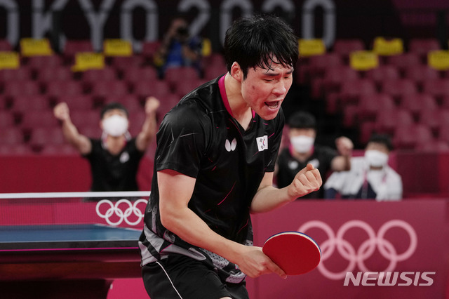 South Korea&#039;s Jang Woo-jin celebrates after winning the table tennis men&#039;s team round of 16 against Slovenia&#039;s Deni Kozul at the 2020 Summer Olympics, Sunday, Aug. 1, 2021, in Tokyo, Japan. (AP Photo/Kin Cheung)