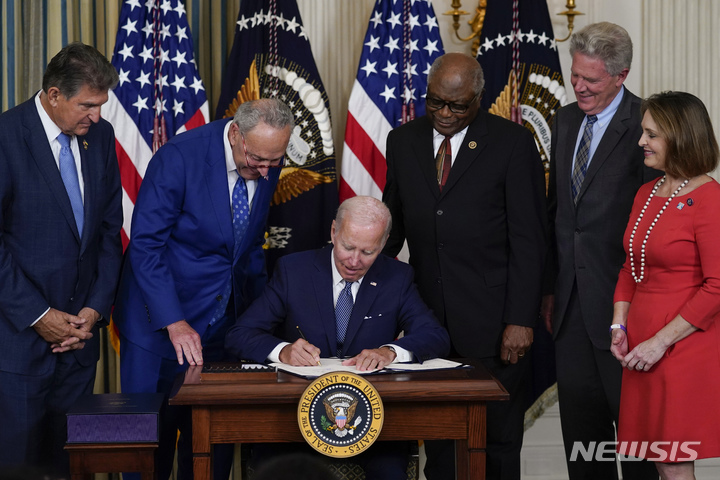 [워싱턴=AP/뉴시스] 조 바이든 미국 대통령이 지난달 16일(현지시간) 백악관 스테이트 다이닝룸에서 기후변화 대응과 의료보장 확충 등의 내용이 담긴 '인플레이션 감축법'에 서명하고 있는 모습. 2022.08.17.