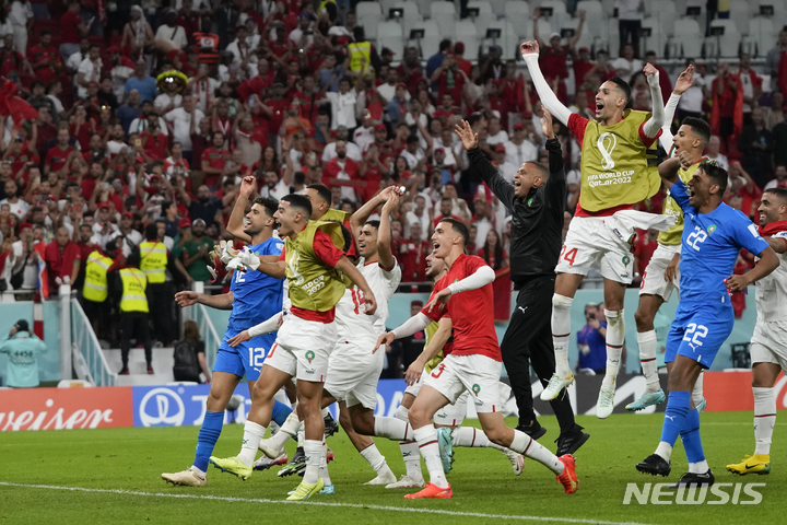 Morocco players celebrate after the World Cup group F soccer match between Belgium and Morocco, at the Al Thumama Stadium in Doha, Qatar, Sunday, Nov. 27, 2022. (AP Photo/Frank Augstein)