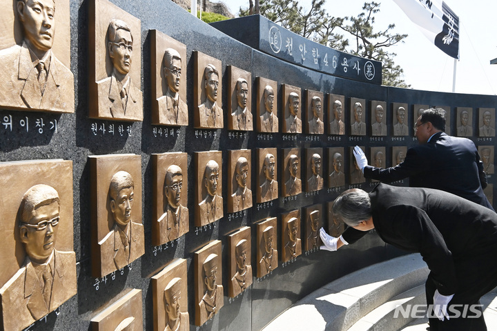 [평택=뉴시스] 김종택 기자 = 26일 경기도 평택시 해군 제2함대 사령부에서 열린 '제13주기 천안함 46용사 추모식'에서 유가족이 추모비에 새겨진 얼굴을 어루만지고 있다. 이날 열린 추모식에는 당시 숨진 군인 유가족과 천암함 승조원, 해군 관계자 등 200여 명이 참석했다. 2023.03.26. jtk@newsis.com