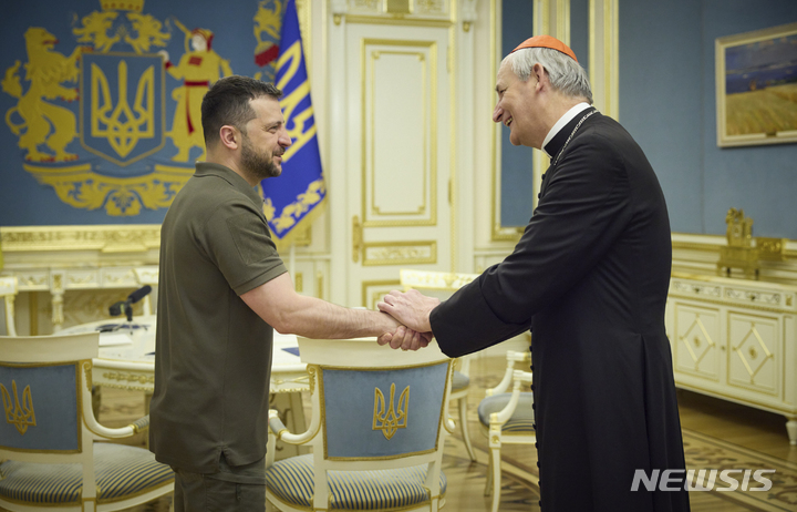 [키이우=AP/뉴시스] 우크라이나 대통령실이 제공한 사진에 볼로디미르 젤렌스키(왼쪽) 우크라이나 대통령이 6일(현지시각) 키이우에서 교황의 평화 특사인 마테오 주피 추기경과 악수하고 있다. 2023.06.07