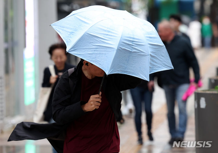 [서울=뉴시스] 추상철 기자 = 강풍과 함께 비가 내린 지난 6일 오후 서울 중구 세종대로 사거리 인근에서 우산을 쓴 시민이 우산으로 바람을 막으며 발걸음을 옮기고 있다. 2024.05.06. scchoo@newsis.com