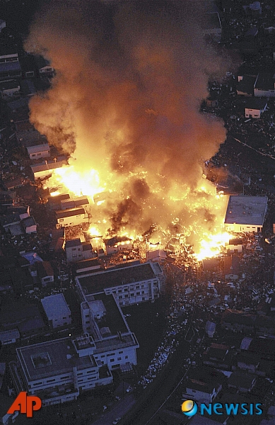 【야마다(일본)=AP/뉴시스】11일 일본 동북부에 규모 8.9의 강진이 발생한 가운데 이와테현 야마다 곳곳에서 화재가 발생해 가옥들이 불에 타고 있다.  