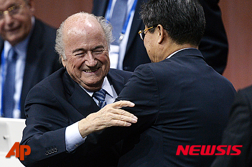 FIFA president Sepp Blatter is greeted after his re-election during the 65th FIFA Congress held at the Hallenstadion in Zurich, Switzerland, Friday, May 29, 2015. Blatter has been re-elected as FIFA president for a fifth term, chosen to lead world soccer despite separate U.S. and Swiss criminal investigations into corruption. The 209 FIFA member federations gave the 79-year-old Blatter another four-year term on Friday after Prince Ali bin al-Hussein of Jordan conceded defeat after losing 133-73 in the first round. (Walter Bieri/Keystone via AP)