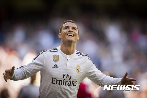 FILE - In this April 5, 2015, file photo, Real Madrid's Cristiano Ronaldo celebrates after scoring a goal during a La Liga soccer match against Granada at the Santiago Bernabeu stadium in Madrid. A group of European media outlets on Friday, Dec. 2, 2016, published what it claims are details of tax arrangements made by several top soccer players and coaches, including Ronaldo, Manchester United manager Jose Mourinho and Arsenal midfielder Mesut Ozil. (AP Photo/Daniel Ochoa de Olza, File)
