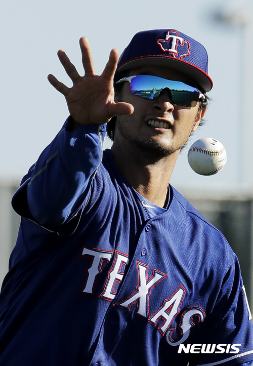 Texas Rangers pitcher Yu Darvish participates in a drill during spring training baseball practice Thursday, Feb. 16, 2017, in Surprise, Ariz. (AP Photo/Charlie Riedel)