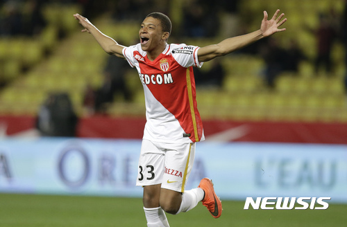FILE - In this Saturday, Feb. 20, 2016 file photo, Monaco's Kylian Mbappe Lottin celebrates scoring the third goal against Troyes during their French League One soccer match, in Monaco. Because of his electric speed and style of play, the 18-year-old Mbappe has drawn comparisons with Thierry Henry, who is also France's record scorer. (AP Photo/Lionel Cironneau, File)