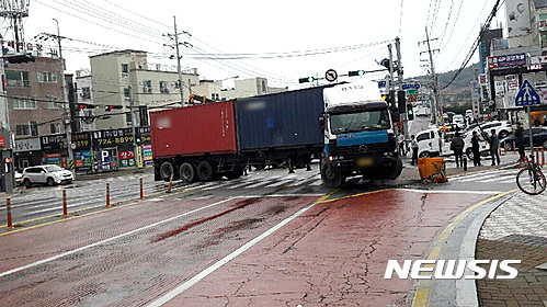 【부산=뉴시스】하경민 기자 = 21일 오전 6시 5분께 부산 기장군 기장읍의 한 교차로에서 트레일러가 빗길에 미끄러져 신호등을 들이받는 사고가 났다. 2017.03.21. (사진=부산경찰청 제공)  yulnetphoto@newsis.com