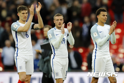 England's John Stones, Jamie Vardy and Dele Alli, from left, clap hands to supporters after winning the World Cup Group F qualifying soccer match between England and Lithuania at the Wembley Stadium in London, Great Britain, Sunday, March 26, 2017. England won the match with 2-0. (AP Photo/Frank Augstein)