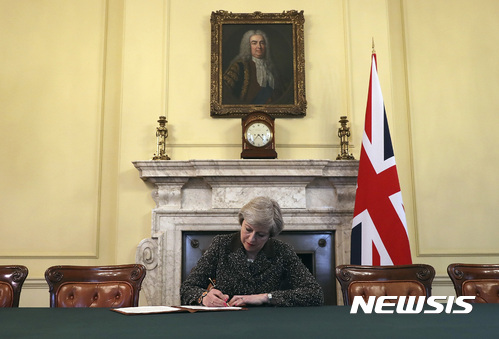 【런던=영국총리실 ·AP/뉴시스】테리사 메이 영국 총리가 28일(현지시간) 런던 총리관저에서 도널트 투스크 유럽이사회 의장에게 영국의 유럽연합 탈퇴를 통보하는 서한에 서명하고 있다. 2017.03. 29 