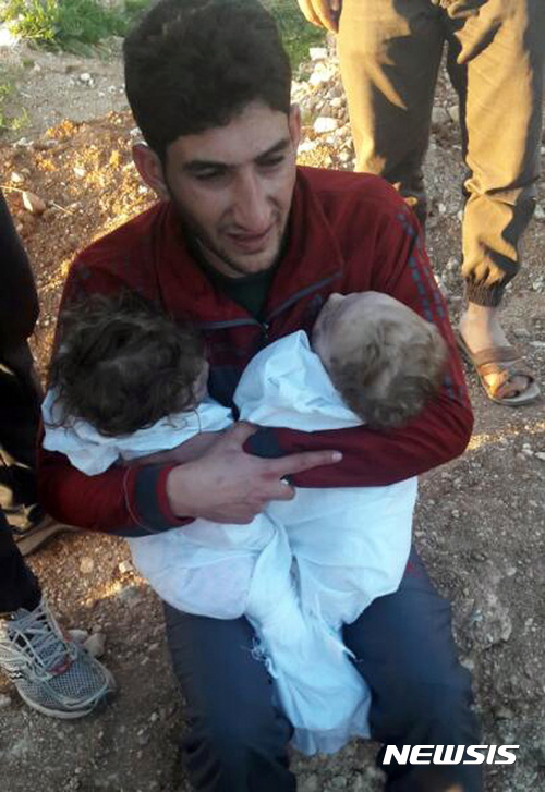 【칸셰이쿤=AP/뉴시스】화학무기 의심 공격이 발생한 시리아 북부 이들리브의 칸셰이쿤에서 4일(현지시간) 한 남성이 숨진 쌍둥이 시신을 안고 오열하고 있다. 이 남성은 이번 사태로 자식들은 물론 아내와 형제, 친척 수십 명을 잃었다.2017.4.6. 