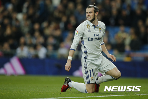 FILE - In this file photo dated Wednesday March 1, 2017, Real Madrid's Gareth Bale reacts during a Spanish La Liga soccer match between Real Madrid and Las Palmas at the Santiago Bernabeu stadium in Madrid, Spain. Real Madrid will have to continue its push toward its first Spanish league title in five years without the injured Gareth Bale, after Coach Zidane Zidane confirmed Friday April 14, 2017, a leg injury will stop Bale playing upcoming Saturday. (AP Photo/Paul White, FILE)