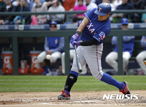 Texas Rangers Shin-Soo Choo hits a three-run home run in the second inning of a baseball game against the Seattle Mariners, Sunday, April 16, 2017, in Seattle. (AP Photo/Ted S. Warren)