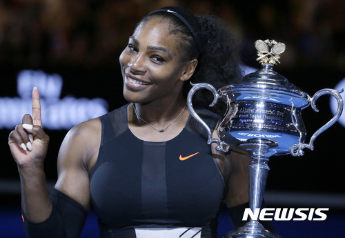 FILE - In this Jan. 28, 2017, file photo, Serena Williams holds up a finger and her trophy after defeating her sister, Venus, in the women's singles final at the Australian Open tennis championships in Melbourne, Australia. A spokeswoman for Williams says the tennis star is pregnant. Kelly Bush Novak wrote in an email to The Associated Press on Wednesday, April 19, 2017: "I'm happy to confirm Serena is expecting a baby this Fall." Earlier in the day, Williams posted a photo of herself on the social media site Snapchat with the caption "20 weeks." (AP Photo/Aaron Favila, File)