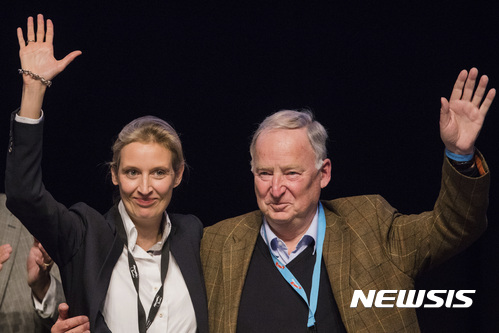 Alice Weidel, left, and Alexander Gauland, members of the AfD (Alternative for Germany) wave to the delegates during the party convention in Cologne, Germany, Sunday, April 23, 2017. The delegates elected Weidel and Gauland as new top candidates for the September general election on Sunday, after the party’s best-known politician, Frauke Petry, said she would no longer be available. (Rolf Vennenbernd//dpa via AP)