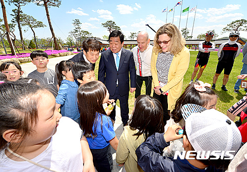 【안동=뉴시스】류상현 기자 = 주한미국대사관 자전거외교단과 경북도 우병윤 경제부지사(가운데) 등 도 관계자들이 경북도청을 견하하고 있는 어린이들을 만나 반갑게 인사하고 있다. 2017.04.27 (사진=경북도 제공)  photo@newsis.com