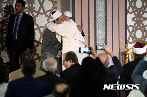 Pope Francis hugs Sheikh Ahmed el-Tayeb, Al-Azhar’s grand imam, at Cairo's Al Azhar university, Friday, April 28, 2017. Francis is in Egypt for a two-day trip aimed at presenting a united Christian-Muslim front that repudiates violence committed in God's name. (L'Osservatore Romano/Pool Photo via AP)