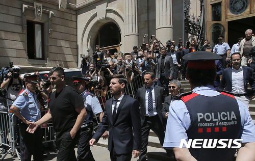 FILE - In this June 2, 2016 file photo, Barcelona soccer player Lionel Messi, center, leaves a court in Barcelona, Spain. Lionel Messi has lost his Supreme Court appeal over a tax-fraud conviction in Spain. The court has confirmed on Wednesday May 24, 2017, the 21-month prison sentence handed to Messi for defrauding tax authorities of 4.1 million euros from 2007-09. He is not expected to go to prison because sentences of less than two years for first offences are usually suspended in Spain.(AP Photo/Manu Fernandez, File)