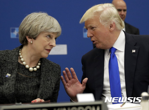 U.S. President Donald Trump, right, speaks to British Prime Minister Theresa May during in a working dinner meeting at the NATO headquarters during a NATO summit of heads of state and government in Brussels on Thursday, May 25, 2017. US President Donald Trump inaugurated the new headquarters during a ceremony on Thursday with other heads of state and government. (AP Photo/Matt Dunham, Pool)