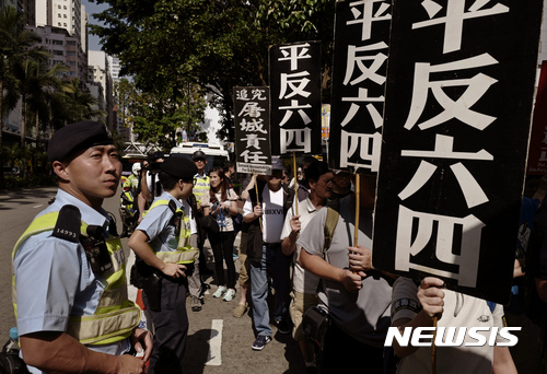 【홍콩=AP/뉴시스】28일 홍콩 도심에서 중국 톈안먼사태(6.4 민주화 운동) 28주기 기념 추모 행진이 열린 가운데 경찰들이 경계를 강화하고 있다. 이날 행진에 약 1000명이 참석했는데 이는 연례 거리행진 최소 규모로 알려졌다. 2017.05.29 