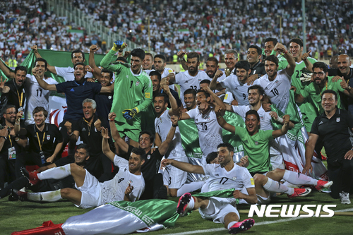 Iran national soccer team celebrates after beating Uzbekistan in their Asia Group A, 2018 World Cup qualifying soccer match at the Azadi Stadium in Tehran, Iran, Monday, June 12, 2017. Iran became the second team to qualify for the 2018 World Cup by beating Uzbekistan 2-0. (AP Photo/Vahid Salemi)