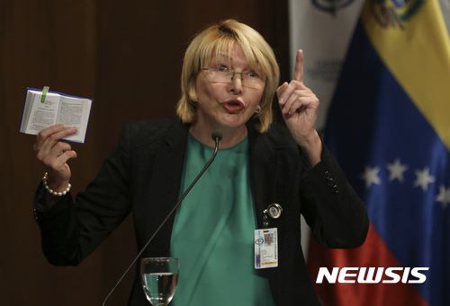 【카라카스(베네수엘라)=AP/뉴시스】루이사 오르테가 디아즈 베네수엘라 검찰총장이 28일(현지시간) 카라카스에서 베네수엘라 헌법을 손에 든 채 기자회견을 하고 있다. 베네수엘라 대법원은 이날 디아즈 총장을 출국금지시키고 그녀의 예금계좌를 동결시켰다. 그녀는 최근 니콜라스 마두로 대통령에 대한 비난 수위를 계속 높여 대표적인 마두로 대통령 비난 세력으로 꼽히고 있다. 2017.6.29