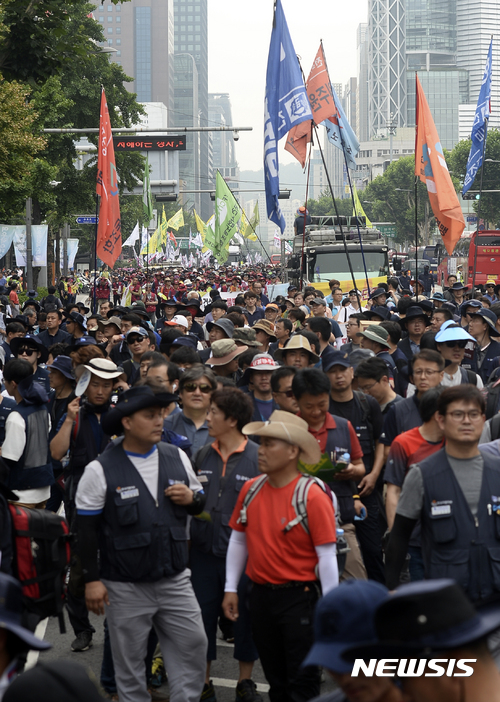 【서울=뉴시스】최진석 기자 = 30일 오후 서울 광화문 광장에서 '6.30 사회적 총파업대회'를 마친 노동자들이 최저임금 1만원 쟁취, 비정규직 철폐, 노조 할 권리 쟁취를 주장하며 종로3가를 향해 행진하고 있다.이날 열린 6.30 사회적 총파업 대회에는 파업 조합원 및 단체행동 참가자, 만원행동 소속 단체, 청년알바노동자 등 4만여 명이 참가했다. 2017.06.30.myjs@newsis.com