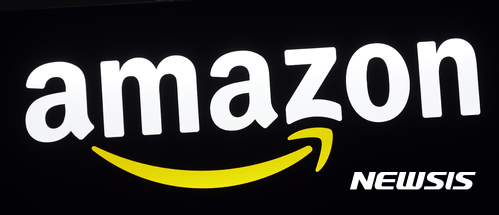 FILE - This Aug. 7, 2017, file photo shows an Amazon sign at a store in Hialeah, Fla. Kohl's says it will open up Amazon shops in 10 of its stores, making it the latest department store operator to make a deal with the e-commerce giant. Kohl's Corp., based in Menomonee Falls, Wis., said Wednesday, Sept. 6, that the Amazon shops will open next month in Chicago and Los Angeles stores. (AP Photo/Alan Diaz, File) 