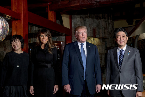 U.S. President Donald Trump and first lady Melania Trump, second from left, pose for photographers with Japanese Prime Minister Shinzo Abe, right, and his wife Akie Abe, left, at Ginza Ukai Tei restaurant, Sunday, Nov. 5, 2017, in Tokyo. Trump is on a five-country trip through Asia traveling to Japan, South Korea, China, Vietnam and the Philippines. (AP Photo/Andrew Harnik)