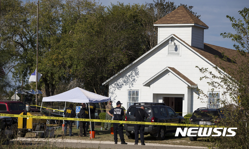 Law enforcement officials works at the scene of a fatal shooting at the First Baptist Church in Sutherland Springs, Texas, on Sunday, Nov. 5, 2017. (Nick Wagner/Austin American-Statesman via AP)