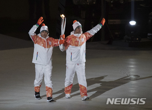 North and South Korea athletes, from left, Choi Bogue and MA Yu Chol wave during the opening ceremony for the XII Paralympic Winter Games in the Pyeongchang Olympic Stadium in Pyeongchang, South Korea, Friday, March 9, 2018. (Simon Bruty/OIS/IOC via AP)