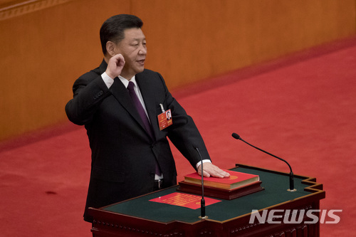 【베이징=AP/뉴시스】17일 베이징 인민대회당에서 열린 13기 중국 전국인민대표대회(전인대) 1차 전체회의에서 국가주석으로 재선출된 시진핑(習近平) 국가주석이 취임 선서를 하고 있다. 2018.3.17 