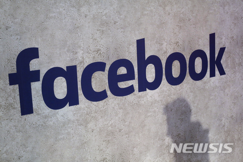 File - This Jan. 17, 2017, file photo shows a Facebook logo being displayed in a start-up companies gathering at Paris' Station F, in Paris. A former employee of a Trump-affiliated data-mining firm says it used algorithms that "took fake news to the next level" using data inappropriately obtained from Facebook. (AP Photo/Thibault Camus, File)