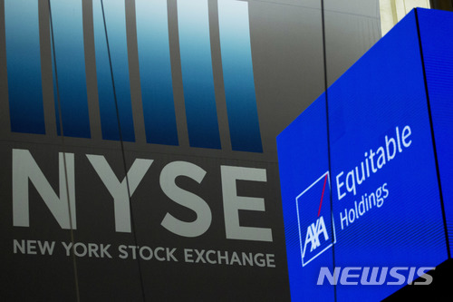 An electronic screen displays a listing for AXA Equitable Holdings, Thursday, May 10, 2018, in New York. The American operations for French insurance giant Axa SA had its IPO at the New York Stock Exchange Thursday. (AP Photo/Mark Lennihan)