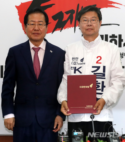 【천안=뉴시스】 자유한국당 홍준표 대표가 14일 오전 서울 여의도 당사 제1회의실에서 국회의원 재보궐선거 천안갑 길환영 후보에게 공천장을 수여하고 기념촬영을 하고 있다. 뉴시스DB.