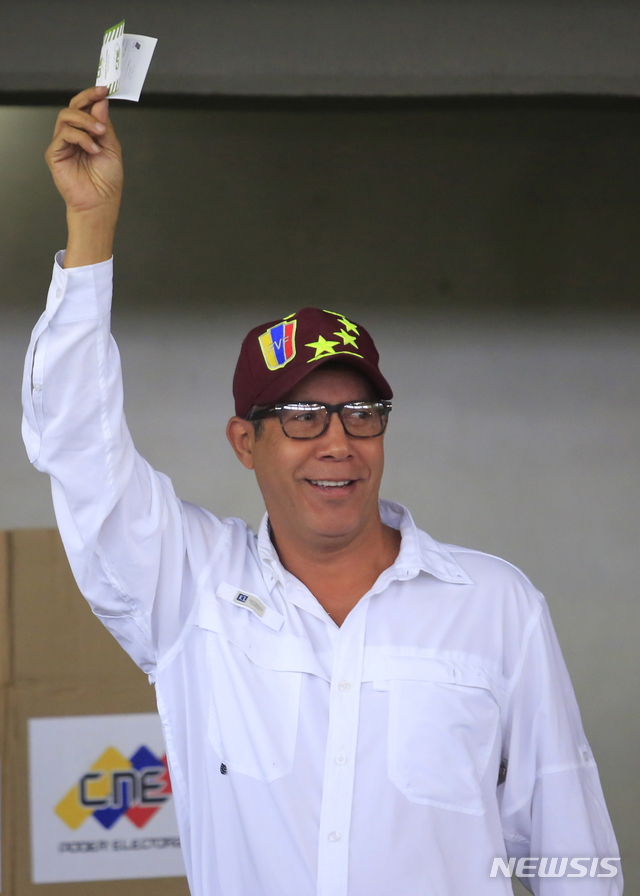 【바르키시메토(베네수엘라)=AP/뉴시스】 2018년 5월20일 치러진 베네수엘라 대선 후보로 나섰던 엔리 팔콘이 바르키시메토 시내 투표소에서 지지자들에게 투표지를 들어보이고 있다.  
