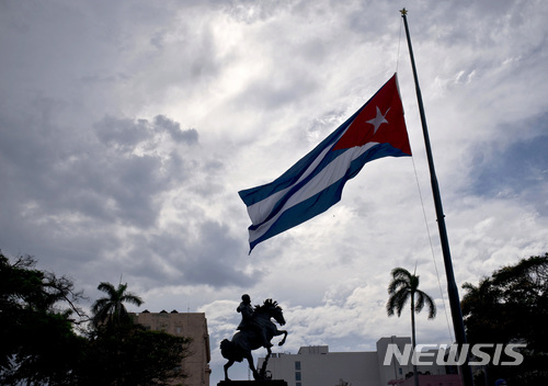 In this Saturday, May 19, 2018 photo, a Cuban flag is seen flying at half-mast near a statue of national hero Jose Marti, marking the start of two days of national mourning, in Havana, Cuba. The Cuban Health Ministry said Friday, May 25, the toll from the crash of the passenger jet in Cuba has risen to 112 after another survivor of the catastrophe died. (AP Photo/Ramon Espinosa)