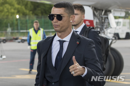 Cristiano Ronaldo gestures as the Portugal national soccer team arrive at Zhukovsky international airport outside Moscow, Russia, Saturday, June 9, 2018 to compete in the 2018 World Cup in Russia. The 21st World Cup begins on Thursday, June 14, 2018, when host Russia takes on Saudi Arabia. (AP Photo/Pavel Golovkin)