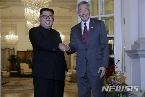 North Korean leader Kim Jong Un meets with Singapore&#039;s Prime Minister Lee Hsien Loong at the Istana or presidential palace on Sunday, June 10, 2018, in Singapore. (AP Photo/Wong Maye-E)