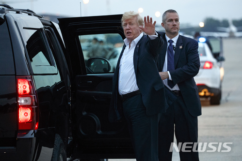 13일 이른 아침 앤드루스 공군기지에 도착한 트럼프 대통령이 기자들에게 말하고 있다.  AP 