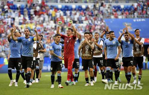 Uruguay players wave to their fans following their 3-0 win over Russia in their group A match at the 2018 soccer World Cup at the Samara Arena in Samara, Russia, Monday, June 25, 2018. (AP Photo/Martin Meissner)
