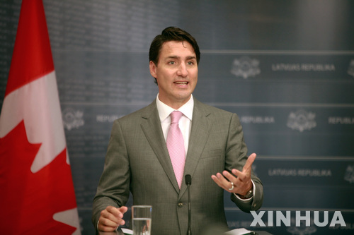 (180710) -- RIGA, July 10, 2018 (Xinhua) -- Canadian Prime Minister Justin Trudeau speaks during a joint press conference with Latvian Prime Minister Maris Kucinskis (not seen in picture) in Riga, Latvia, on July 10, 2018. Trudeau pledged sustained commitment to Latvia's security during his visit to Riga on Tuesday, saying that Canada would extend its leadership of the NATO battalion stationed in the Baltic country for four more years. (Xinhua/Janis) 