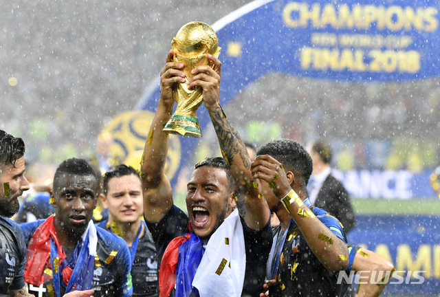 France&#039;s Corentin Tolisso celebrates with the trophy after France won 4-2 during the final match between France and Croatia at the 2018 soccer World Cup in the Luzhniki Stadium in Moscow, Russia, Sunday, July 15, 2018. (AP Photo/Martin Meissner)