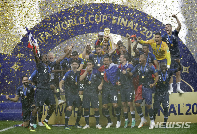 France goalkeeper Hugo Lloris holds the trophy aloft as he celebrates with his teammates after the final match between France and Croatia at the 2018 soccer World Cup in the Luzhniki Stadium in Moscow, Russia, Sunday, July 15, 2018. France won the final 4-2. (AP Photo/Matthias Schrader)