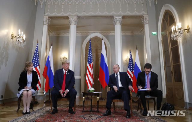 U.S. President Donald Trump, second from left, listens to a statement of Russian President Vladimir Putin, second from right, at the beginning of a meeting at the Presidential Palace in Helsinki, Finland, Monday, July 16, 2018. (AP Photo/Pablo Martinez Monsivais)