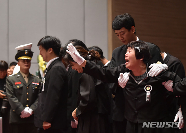 【포항=뉴시스】우종록 기자 = 23일 오전 경북 포항시 남구 해병대 1사단 부대 내 도솔관에서 엄수된 상륙기동헬기 마린온 추락사고 순직 장병 합동영결식에서 유가족이 영정 앞에 오열하고 있다. 2018.07.23.  wjr@newsis.com